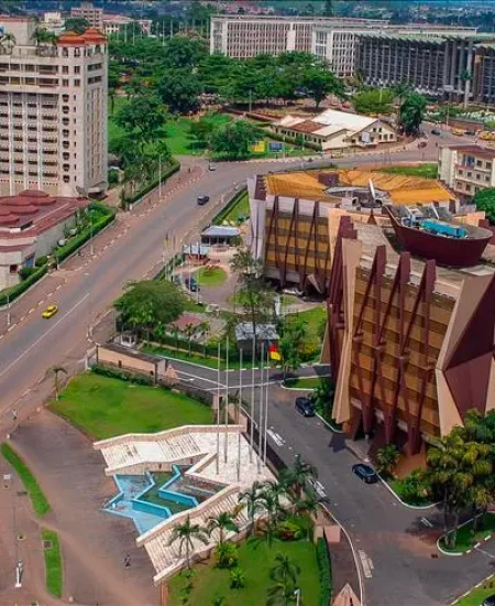 Aerial view showcasing modern commercial buildings in Cameroon, highlighting urban development, road networks, and vibrant cityscape.